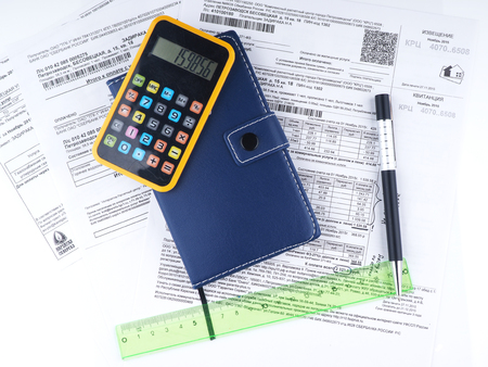 bills, money, calculator and pen on a light backgroundの写真素材