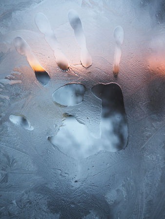 trace their hands on a frozen glass