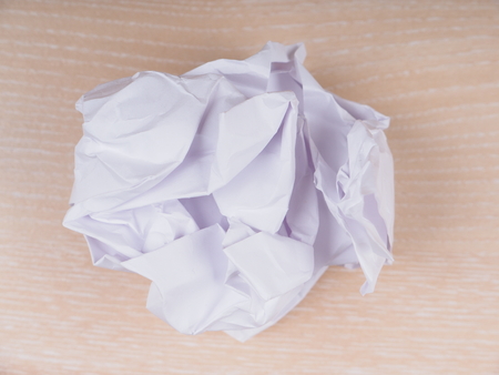crumpled paper on a wooden background