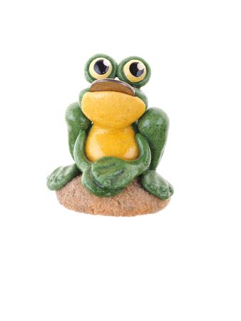 toy frog with a coin in his mouth on a white backgroundの写真素材