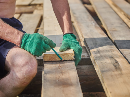 Builder drawing on a wooden board