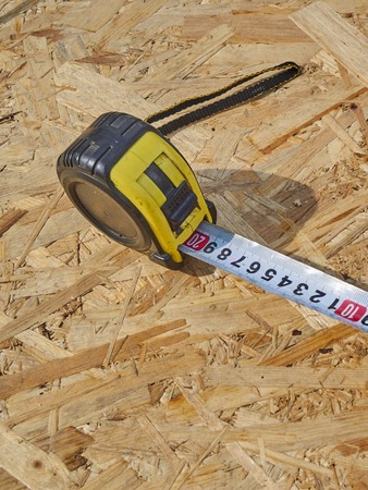 Construction ruler on a wooden backgroundの写真素材