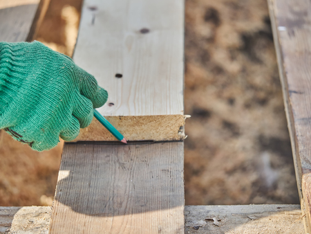 Builder drawing on a wooden boardの写真素材