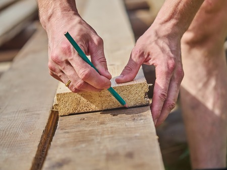 Builder drawing on a wooden boardの写真素材