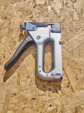 Construction stapler on a wooden backgroundの写真素材
