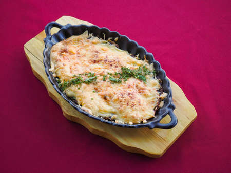 Beefsteak with tomato and herbs on a red backgroundの写真素材