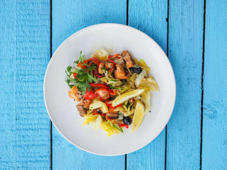 Chicken salad on blue wooden background