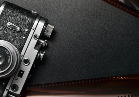 Vintage photo camera on black background