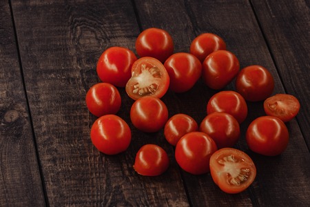 tasty cherry tomatoes on a wooden stand, wooden background.の写真素材