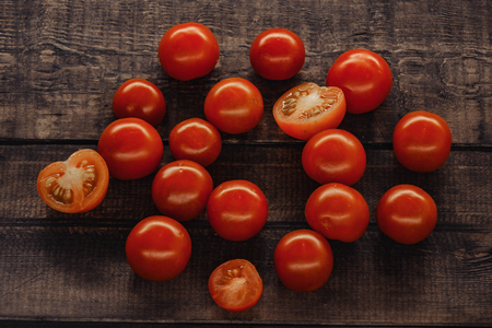 tasty cherry tomatoes on a wooden stand, wooden background.の写真素材