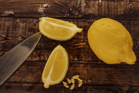 yellow, fresh lemon. lemon slices on wooden background.の写真素材