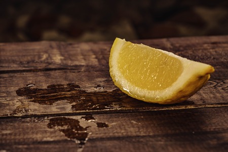 yellow, fresh lemon. lemon slices on wooden background.の写真素材