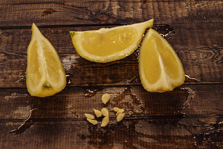 yellow, fresh lemon. lemon slices on wooden background.の写真素材