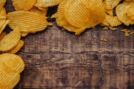 crispy potato chips on wooden background. chips started.