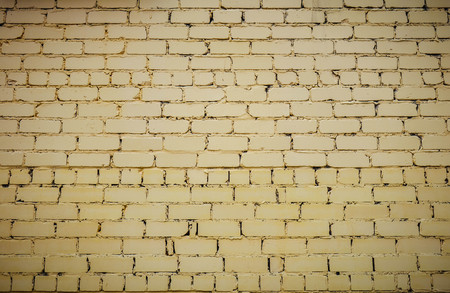 horizontal part of bright yellow painted brick wall.