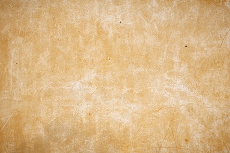 old beige wall with small holes in the wall.の写真素材