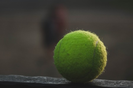 tennis ball lying on a metal stand.の写真素材