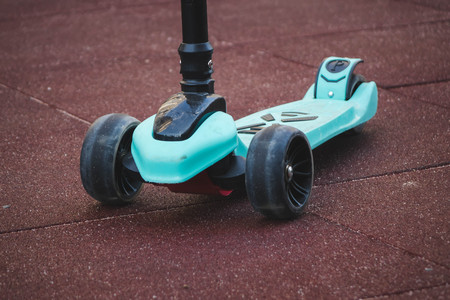 kids scooter blue color on the playground red.の写真素材
