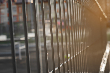 sports ground fenced behind a metal gridの写真素材