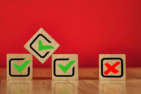 Wooden cubes with drawn marks on the red background.