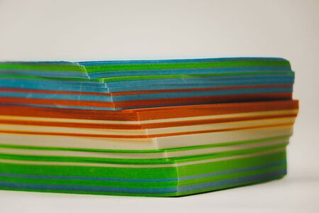 A stack of multicolored note papers on an isolated white background. isolates.の写真素材