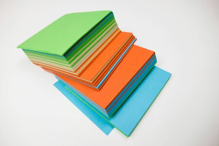 A stack of multicolored note papers on an isolated white background. isolates.