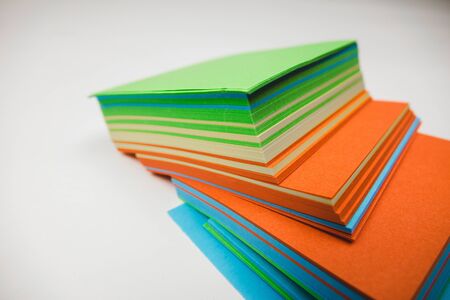 A stack of multicolored note papers on an isolated white background. isolates.の写真素材