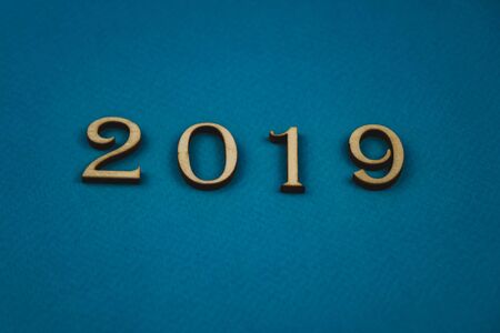2019 number of wooden numbers on blue background.の写真素材