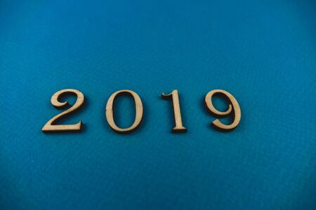 2019 number of wooden numbers on blue background.の写真素材
