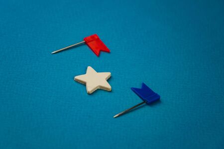 wooden stars and one red on a blue background with a red flag.の写真素材