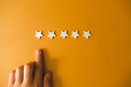 five white stars on an orange background.