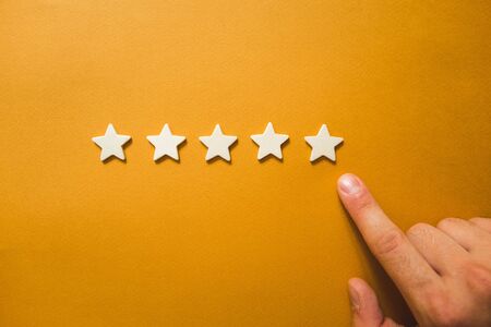 five white stars on an orange background.の写真素材