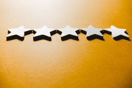 five white stars on an orange background.の写真素材