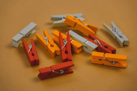 colorful clothespins on a brown background.の写真素材