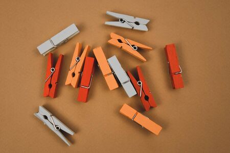 colorful clothespins on a brown background.の写真素材