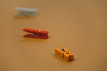 colorful clothespins on a brown background.の写真素材