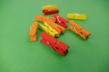 plastic clothespins on a green backgroundの写真素材