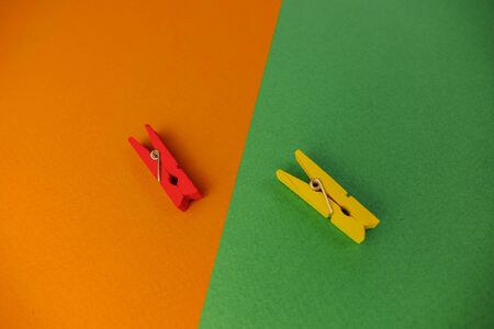 plastic clothespins on a green backgroundの写真素材