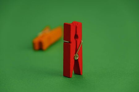 plastic clothespins on a green backgroundの写真素材