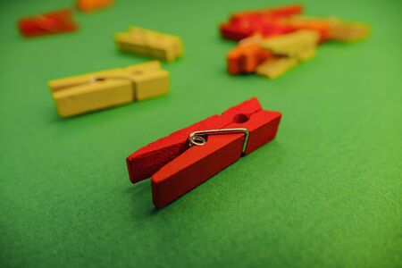 plastic clothespins on a green backgroundの写真素材