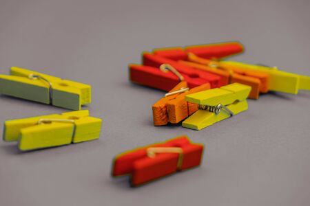 Red plastic clothespins a white background.の写真素材