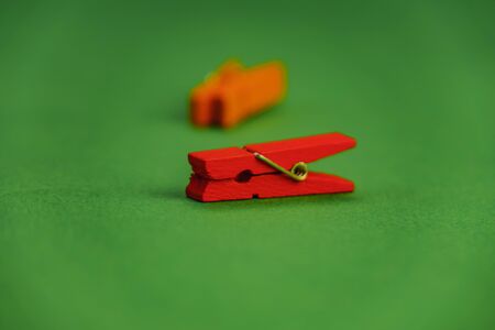plastic clothespins on a green backgroundの写真素材