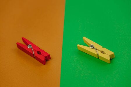 plastic clothespins on a green backgroundの写真素材