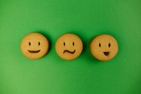 tasty cookies smiles on green backgroundの写真素材