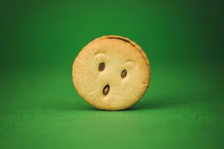 smiling cookies and different emotions on a green background.の写真素材