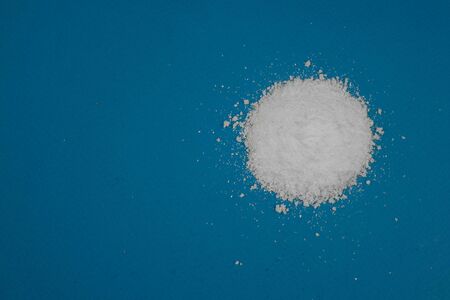 a mountain of white powder on a blue background.の写真素材