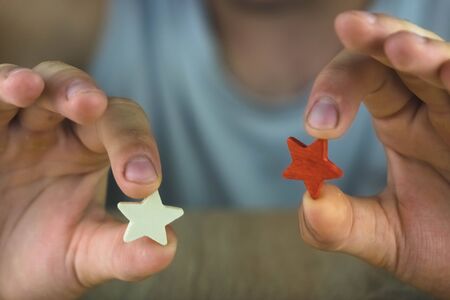 a man holding a red and white star.の写真素材