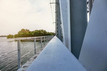 railway bridge passing over the river at sunsetの写真素材