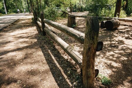 wooden fence in the center of the forest edge.の写真素材