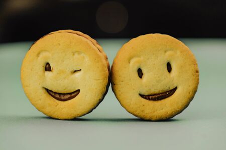 smiling cookies and different emotions on a green background.の写真素材